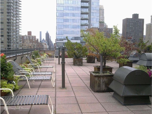 view of patio with a city view and area for grilling