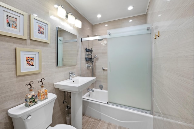 full bathroom featuring tile walls, toilet, bath / shower combo with glass door, ornamental molding, and tasteful backsplash