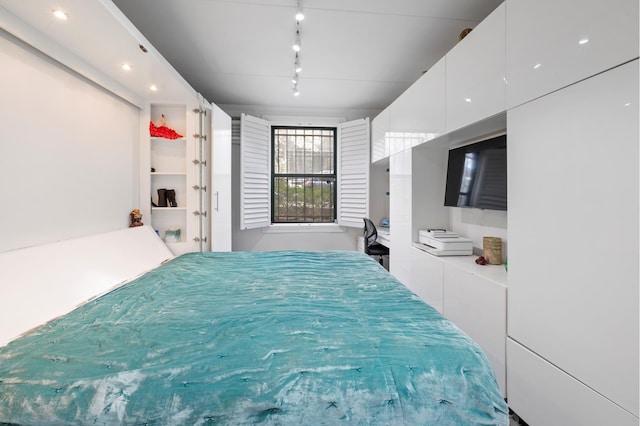 bedroom featuring rail lighting