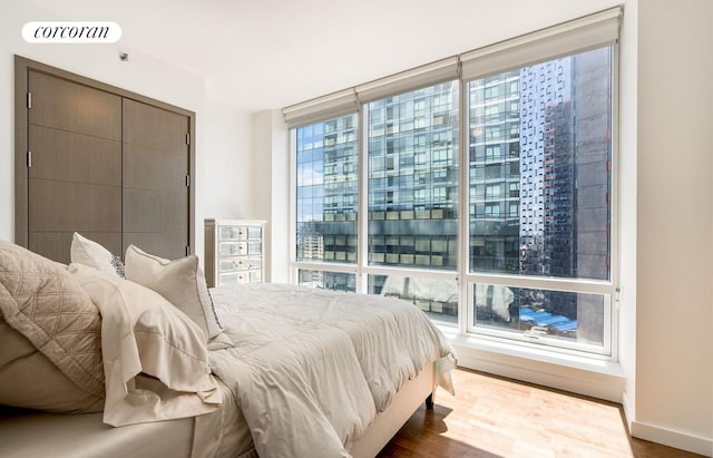 bedroom featuring wood finished floors and baseboards