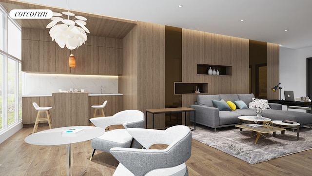 living area featuring light wood finished floors and a chandelier