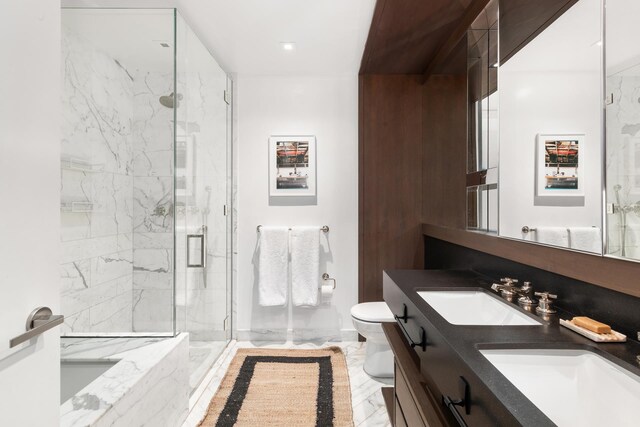 bathroom featuring toilet, marble finish floor, a sink, and a marble finish shower