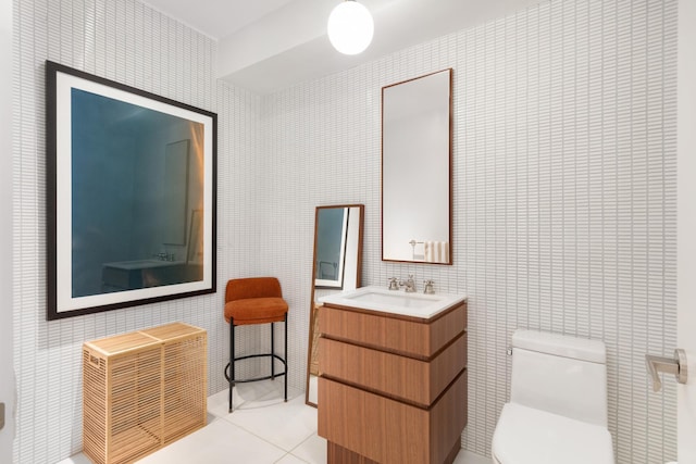 bathroom with tile walls, toilet, tile patterned flooring, and vanity