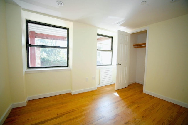 259 21st St Unit 1-C, New York City, NY 11215 - unfurnished bedroom with light wood-style flooring, baseboards, and a closet