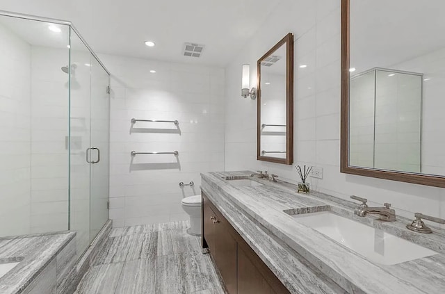 80 Riverside Blvd Unit 8-E, New York City, NY 10069 - bathroom with double vanity, toilet, a shower stall, tile walls, and recessed lighting
