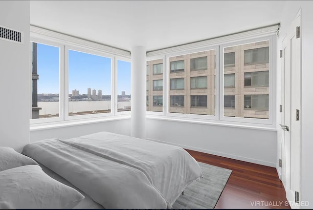 80 Riverside Blvd Unit 8-E, New York City, NY 10069 - bedroom featuring dark wood-style flooring, baseboards, and a view of skyline