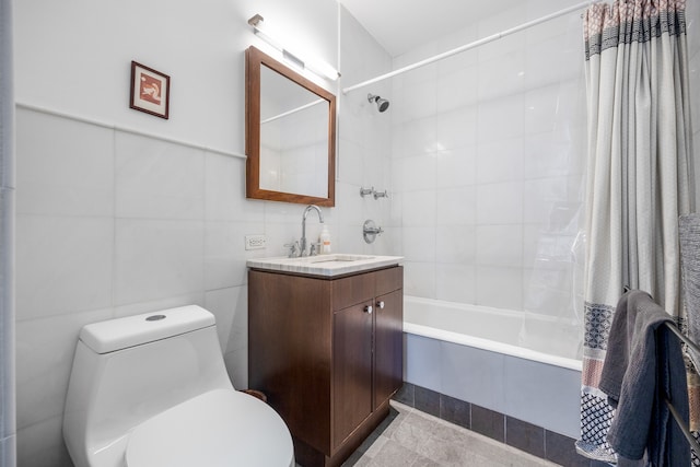 bathroom with tiled shower / bath combo, tile walls, toilet, and vanity
