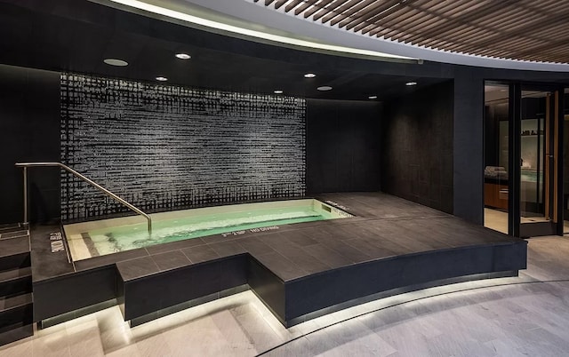 view of swimming pool featuring elevator