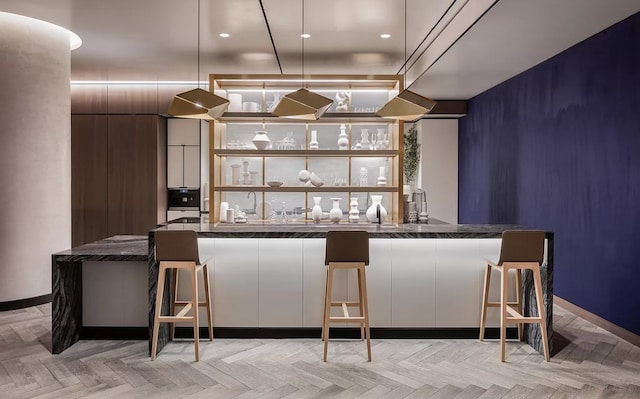 bar with pendant lighting and a community bar