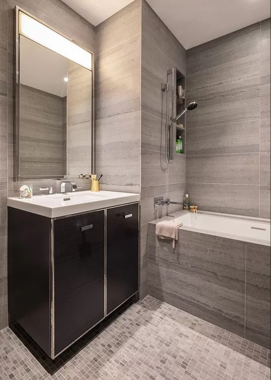 full bath with vanity, shower / washtub combination, and tile walls