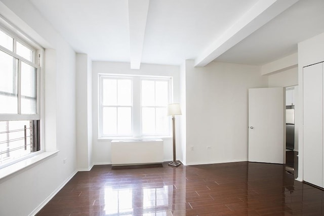 150 W 51st St Unit 1730, New York City, NY 10019 - unfurnished room featuring beam ceiling, wood finished floors, radiator, and baseboards