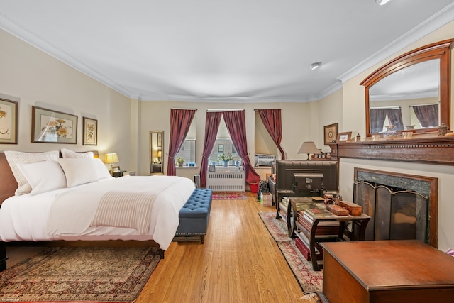 489 W End Ave, New York City, NY 10024 - bedroom featuring a fireplace, radiator heating unit, crown molding, and wood finished floors