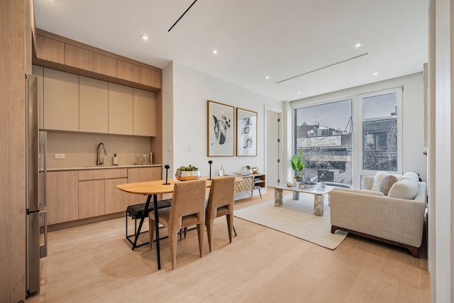 dining room featuring light wood finished floors and recessed lighting