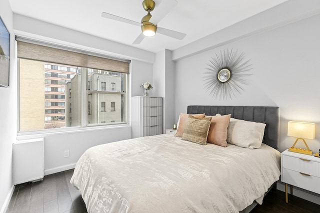 370 E 76th St Unit B-507, New York City, NY 10021 - bedroom featuring radiator, wood finished floors, baseboards, and ceiling fan