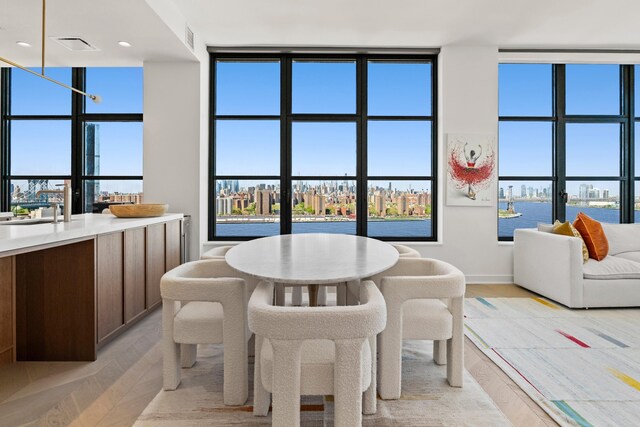 180 Front St Unit 17-E, New York City, NY 11201 - dining space with healthy amount of natural light and a water view