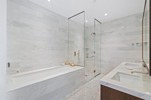 180 Front St Unit 17-E, New York City, NY 11201 - full bathroom featuring a garden tub, double vanity, a tile shower, and tile walls