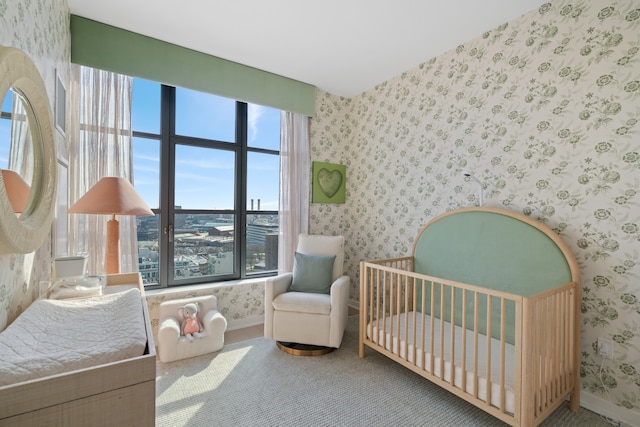 180 Front St Unit 17-E, New York City, NY 11201 - carpeted bedroom with wallpapered walls and a crib