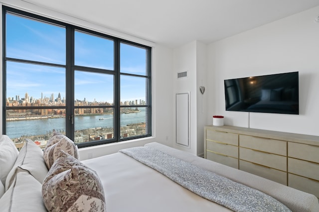 180 Front St Unit 17-E, New York City, NY 11201 - bedroom featuring a view of skyline and multiple windows