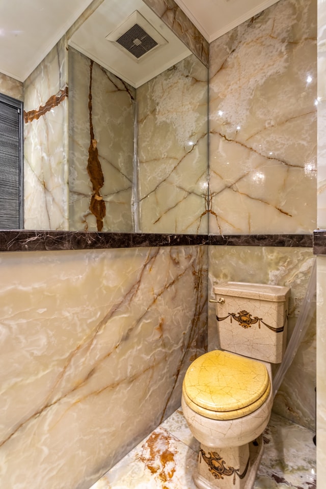 58 W 58th St Unit 30-E, New York City, NY 10019 - bathroom featuring marble tiled flooring, ornamental molding, tile walls, and stone wall