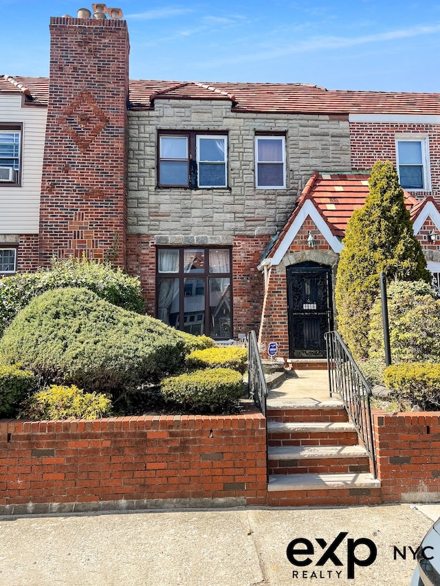 130-22 226th St, New York City, NY 11413 - view of front facade featuring stone siding and a chimney