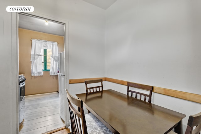 dining space with light wood-type flooring and visible vents