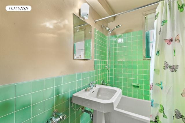 full bathroom featuring tile walls and shower / tub combo