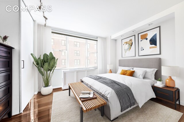 137 E 36th St Unit 8H, New York City, NY 10016 - bedroom with wood finished floors and baseboards