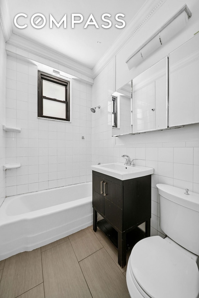 full bathroom featuring toilet, crown molding, tile walls, vanity, and shower / tub combination