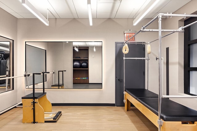 workout room with wood finished floors and baseboards