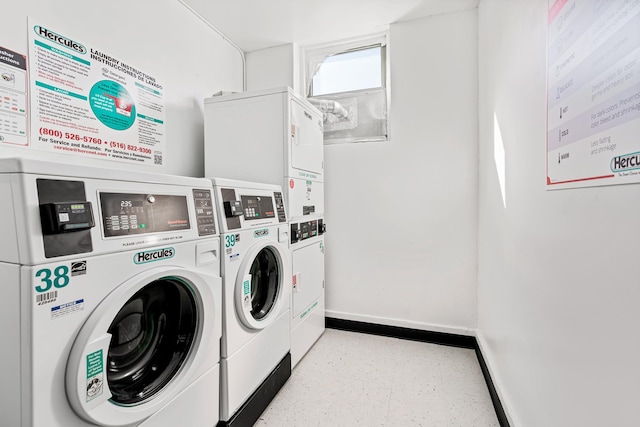 45-02 Ditmars Blvd Unit 231, New York City, NY 11105 - community laundry room featuring washing machine and dryer, stacked washing machine and dryer, baseboards, and tile patterned floors