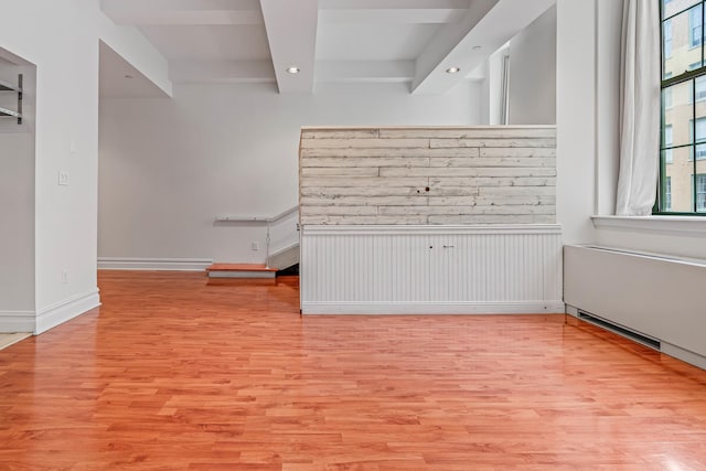 45-02 Ditmars Blvd Unit 231, New York City, NY 11105 - empty room featuring wood finished floors, recessed lighting, beamed ceiling, and baseboards