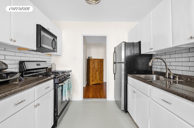 330 Lenox Rd Unit 6F, New York City, NY 11226 - kitchen featuring appliances with stainless steel finishes, a sink, white cabinetry, dark stone countertops, and tasteful backsplash