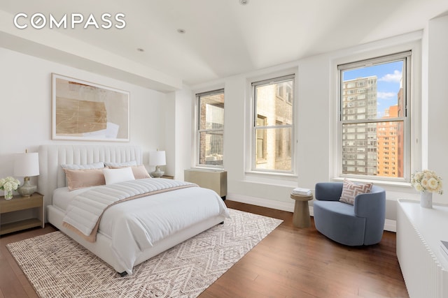 bedroom with baseboards and wood finished floors