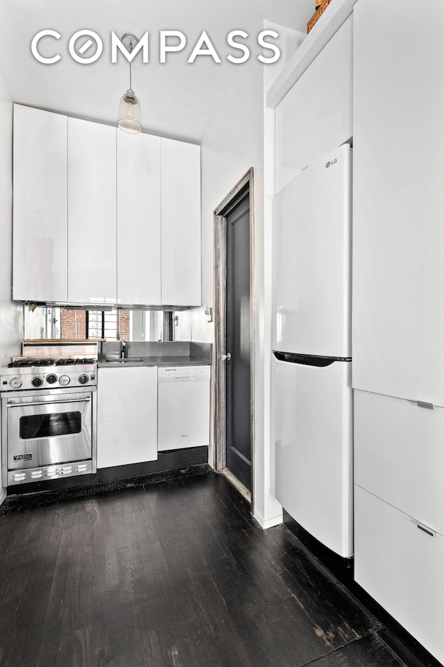 39 W 84th St Unit 3B, New York City, NY 10024 - kitchen featuring white appliances, dark wood finished floors, white cabinetry, a sink, and modern cabinets