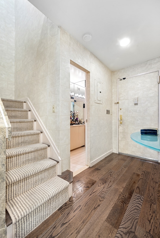 7 E 35th St Unit 14A, New York City, NY 10016 - entryway with wood finished floors, tile walls, and stairway