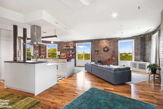 214 Riverside Dr Unit 508/509, New York City, NY 10025 - living area featuring light wood finished floors, brick wall, and a ceiling fan