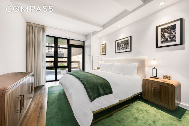 bedroom featuring recessed lighting, dark wood-style flooring, and access to outside