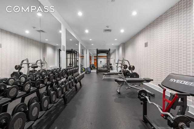 gym featuring wallpapered walls and recessed lighting