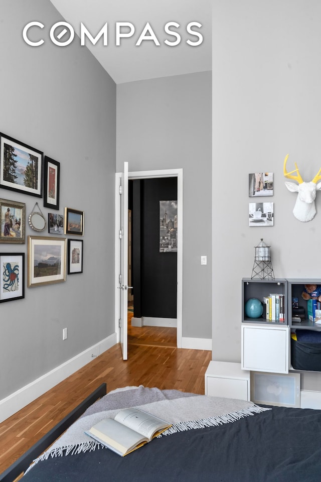 bedroom with wood finished floors and baseboards