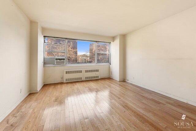 185 Park Row Unit 3F, New York City, NY 10038 - unfurnished room featuring radiator, wood finished floors, baseboards, and cooling unit