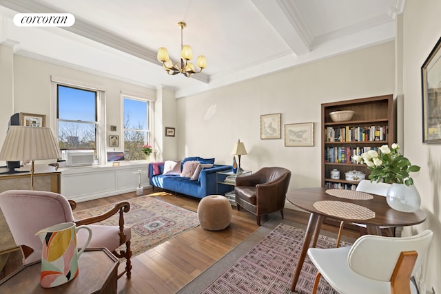 sitting room with visible vents, ornamental molding, wood finished floors, beamed ceiling, and a notable chandelier