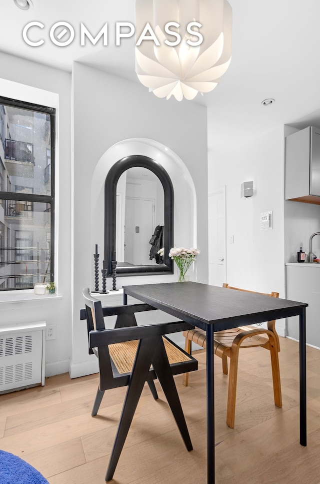 101 Linden St Unit 2D, New York City, NY 11221 - dining room with light wood-style flooring, radiator, and baseboards