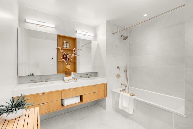 bathroom with double vanity, shower / bathtub combination, tile patterned floors, and a sink