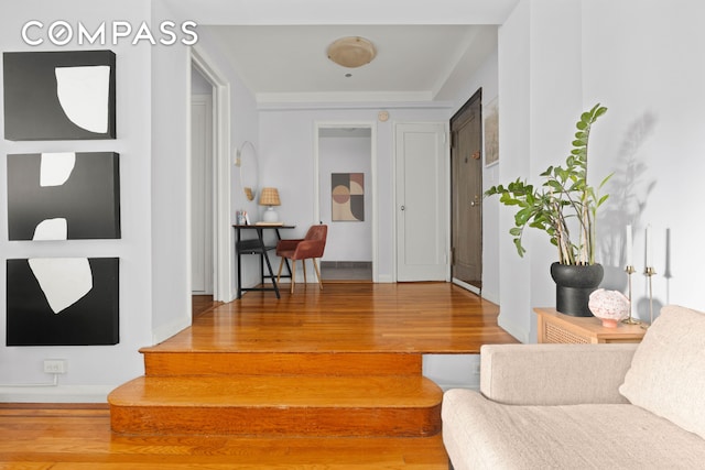 corridor featuring wood finished floors and baseboards
