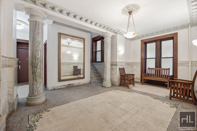 311 W 97th St Unit 3N, New York City, NY 10025 - carpeted spare room featuring decorative columns, wainscoting, and stairway