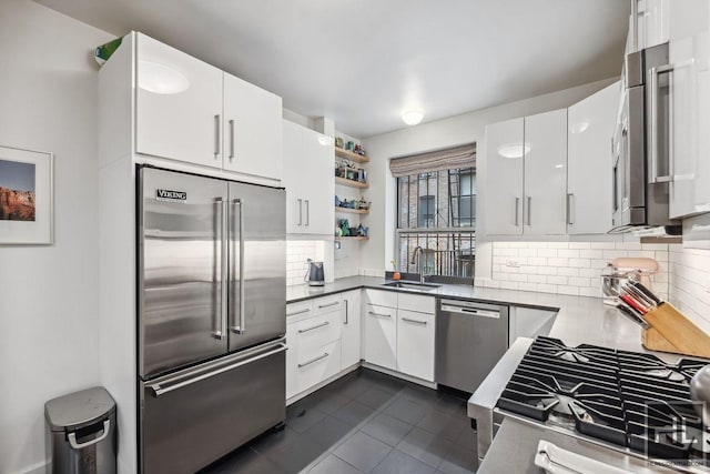 311 W 97th St Unit 3N, New York City, NY 10025 - kitchen with stainless steel appliances, tasteful backsplash, a sink, and dark tile patterned floors