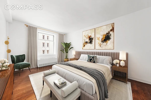 100 W 58th St Unit 11E, New York City, NY 10019 - bedroom featuring radiator heating unit, hardwood / wood-style flooring, and baseboards