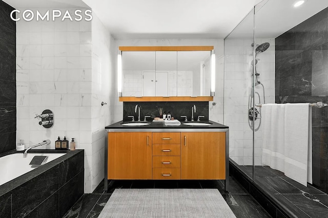 full bathroom featuring tiled bath, a tile shower, double vanity, and a sink