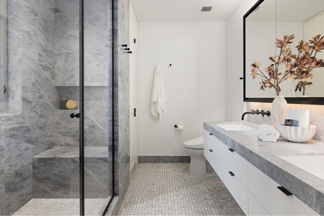 545 W 110th St Unit 6Eg, New York City, NY 10025 - full bathroom featuring tiled shower, double vanity, and tile patterned floors