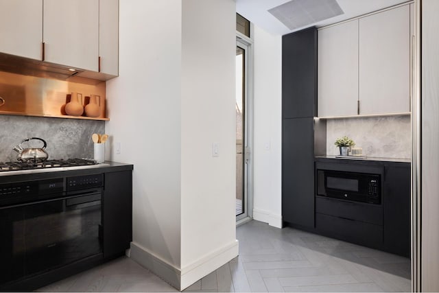 545 W 110th St Unit 6Eg, New York City, NY 10025 - kitchen featuring black appliances, decorative backsplash, baseboards, and white cabinets